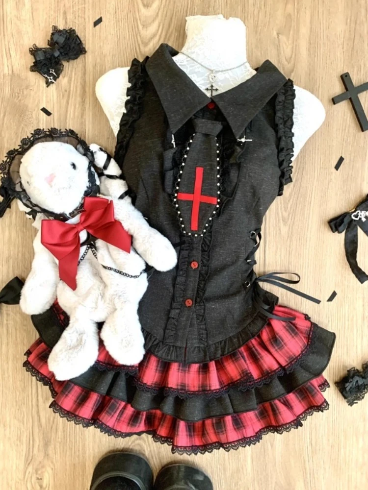 A sleeveless, black dress with a lapel collar and lace details.