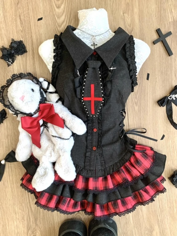 A sleeveless, black dress with a lapel collar and lace details.