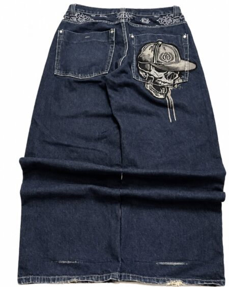 Back view of dark blue wide-leg jeans with skull-and-cap embroidery on the right pocket and embroidered waistband details.