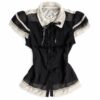 Black fitted blouse with an ivory floral lace collar, ribbon bow, lace-trimmed short sleeves and scalloped hem.